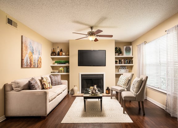 a living room with a ceiling fan and a television at Madison Oaks Apartment Homes, LLC, Palm Harbor, 34684