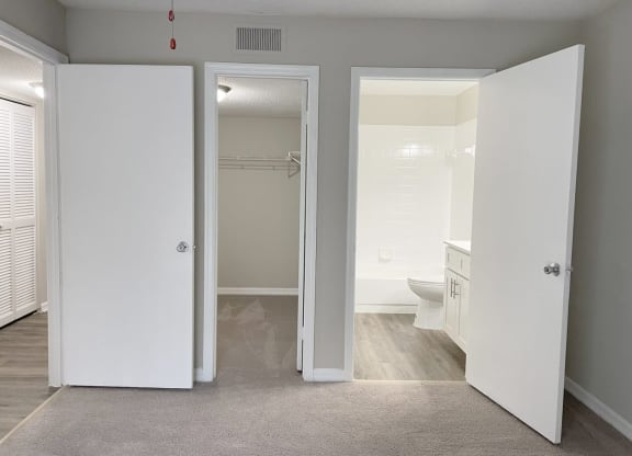 a bedroom with a bathroom and a closet at Madison Oaks Apartment Homes, LLC, Palm Harbor, 34684