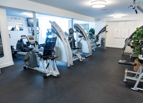 a gym with cardio machines and weights on the floor at Raritan Crossing Apartment Homes, New Brunswick New Jersey