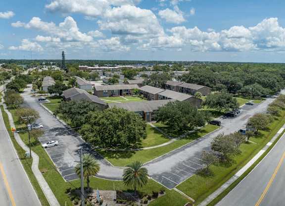 A large building complex with a parking lot in front.