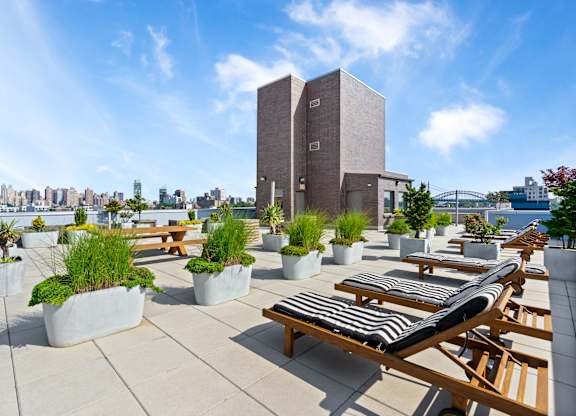 Rooftop Patio with Lounge Chairs at The Grove Apartments, Astoria, NY, 11102