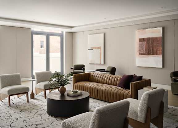 A living room with a sofa, chairs, and a coffee table.