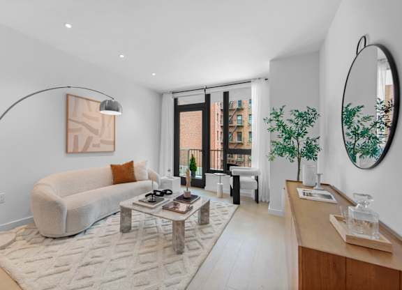 A modern living room with a white couch and a coffee table.