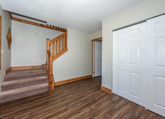 a bedroom with a staircase and a door