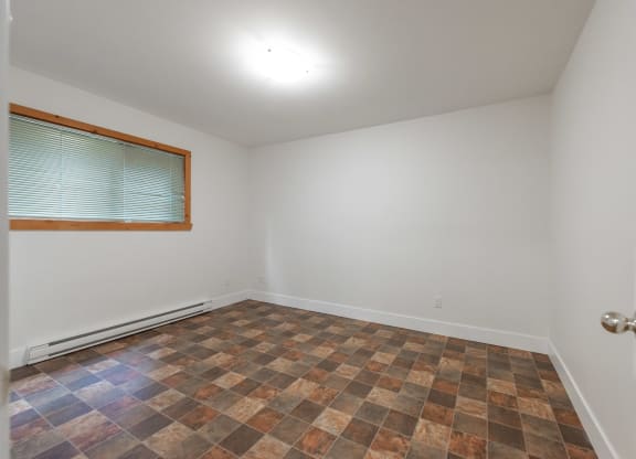 an empty room with a window and a door