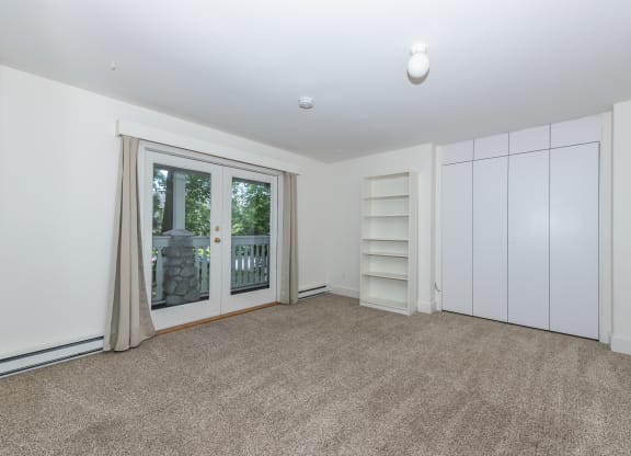 a bedroom with a door to a balcony