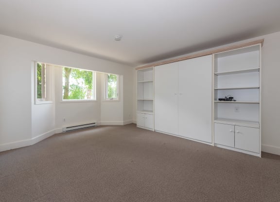 a bedroom with white walls and carpet