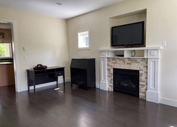 a living room with a fireplace and a television