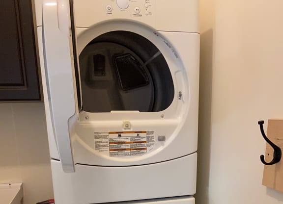 a dryer and a washing machine in a laundry room