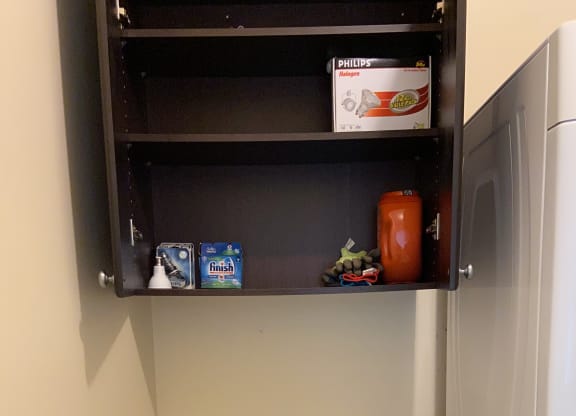 a small refrigerator in the corner of a room