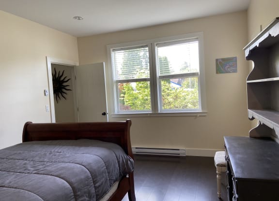 a bedroom with a bed and a dresser
