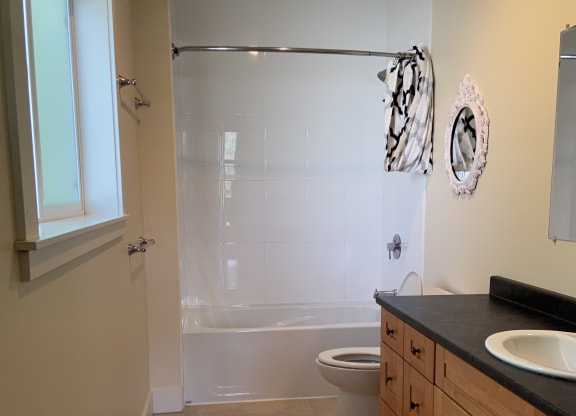 a bathroom with a bathtub and a shower with a glass door