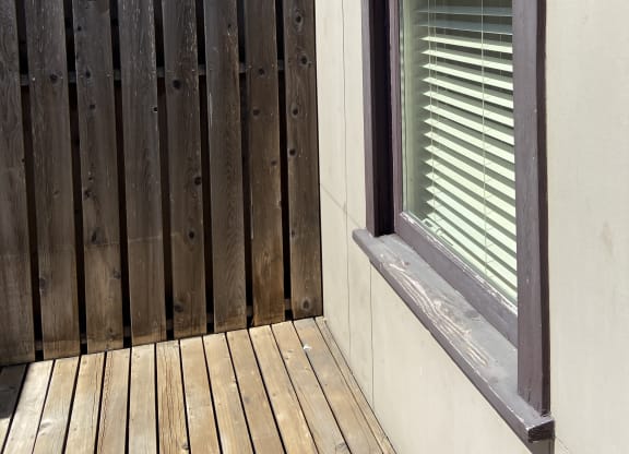 a view of the underside of the stairwell with a wood paneled wall and a glass