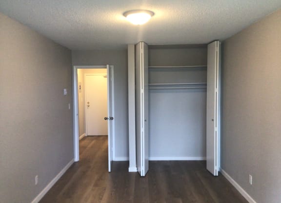 an empty room with a closet and a light on