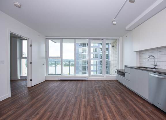 an open kitchen and living room in a 555 waverly unit