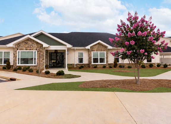 Clubhouse exterior with stone accents and landscaping at The Maxwell Apartments, Rome, GA 30165