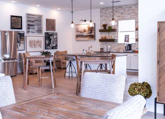 A modern kitchen with a dining table and chairs.