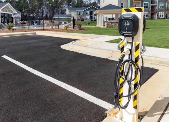 A parking lot with a charging station for electric vehicles.