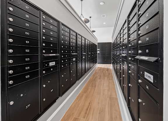 A long hallway with black mailboxes on both sides. at Allegra at Cocoa in Cocoa, FL, 32926