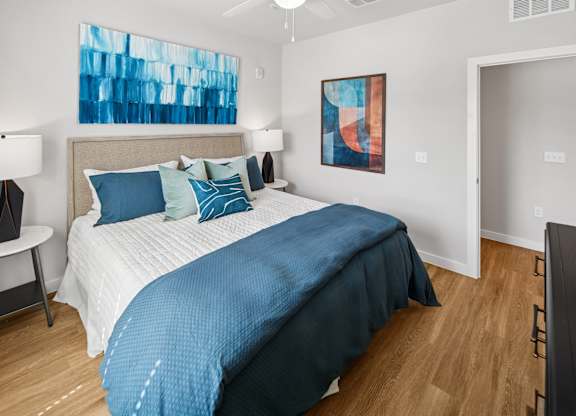 A bedroom with a large bed and a painting on the wall. at Allegra at Cocoa in Cocoa, FL, 32926