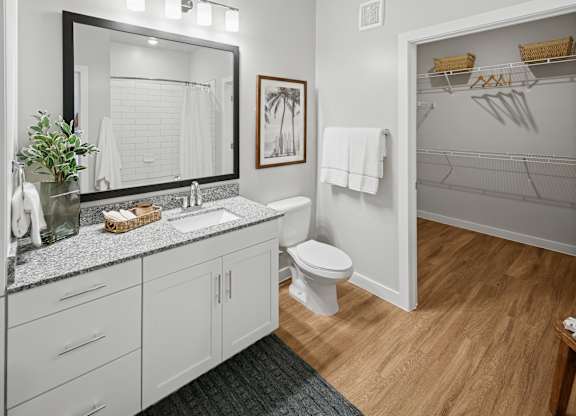 A bathroom with a white toilet and a white sink. at Allegra at Cocoa in Cocoa, FL, 32926