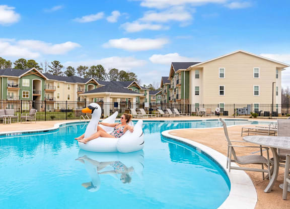 Swimming pool with person on swan float at The Maxwell Apartments, Rome, GA 30165