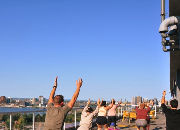 a group of people with their hands in the air at the top of a tower
