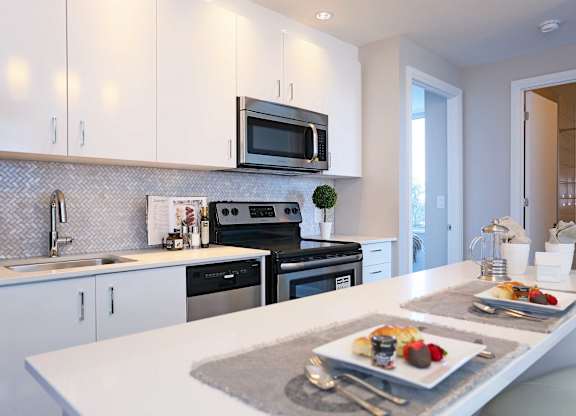 a white kitchen with a plate of food on the counter