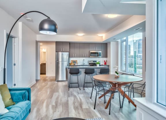 a kitchen and dining room with a table and chairs