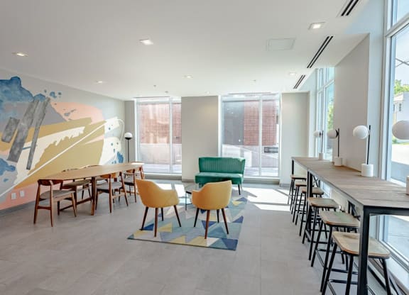 a dining room with tables and chairs and a large window