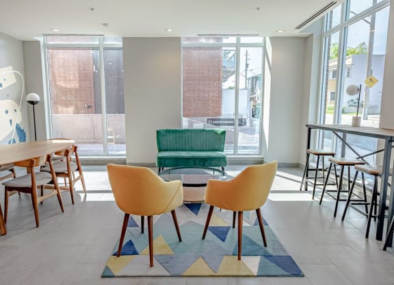 a seating area with a table and chairs in a lobby