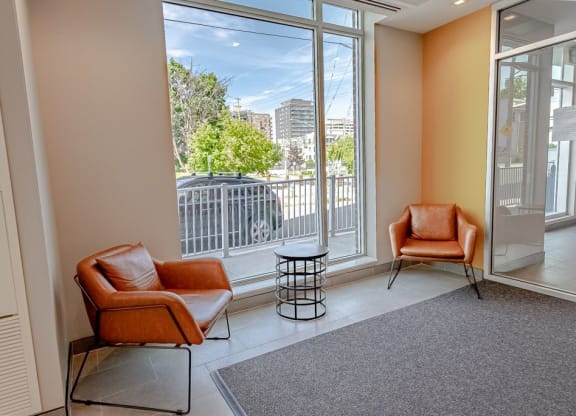 a living room with two chairs and a balcony