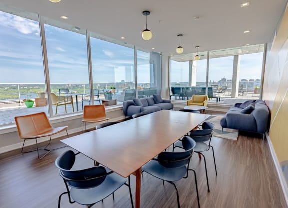a meeting room with a table and chairs and a view of the city
