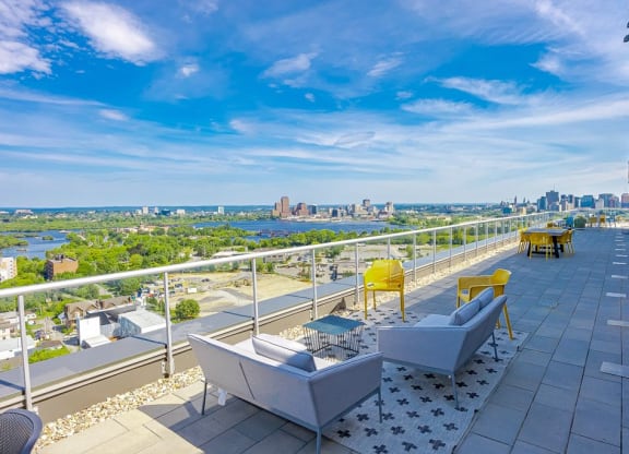 a balcony with a view of the city and a blue sky