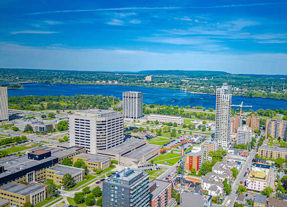 an aerial view of a city with a river and skyscrapers