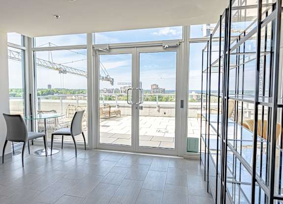 a living room with glass doors and a view of the water