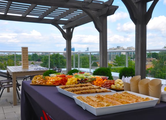 a buffet of food on a table on a roof