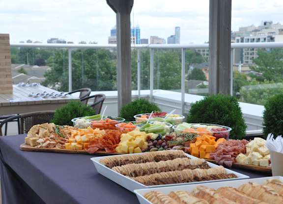 a buffet of food on a table with a city in the background