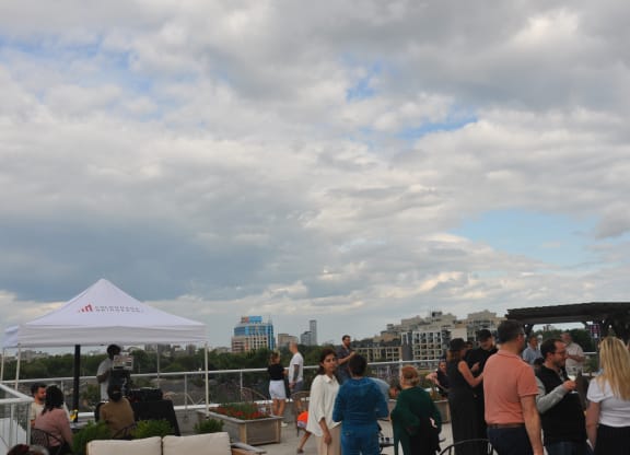 a crowd of people at a party on the roof of a building