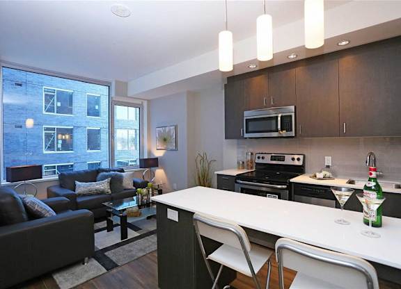 a kitchen and living room with a table and chairs