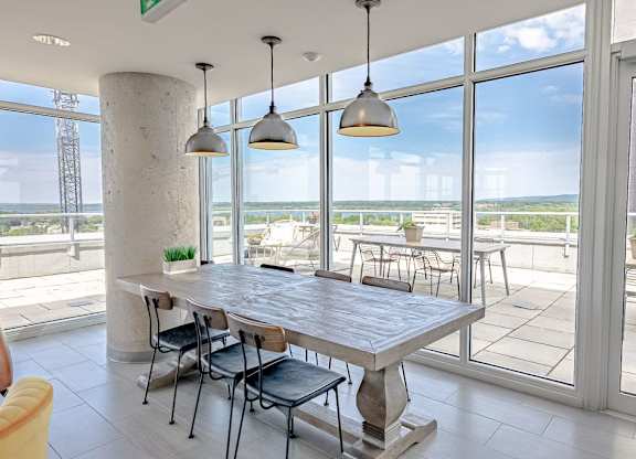 a dining room with large windows and a table with chairs
