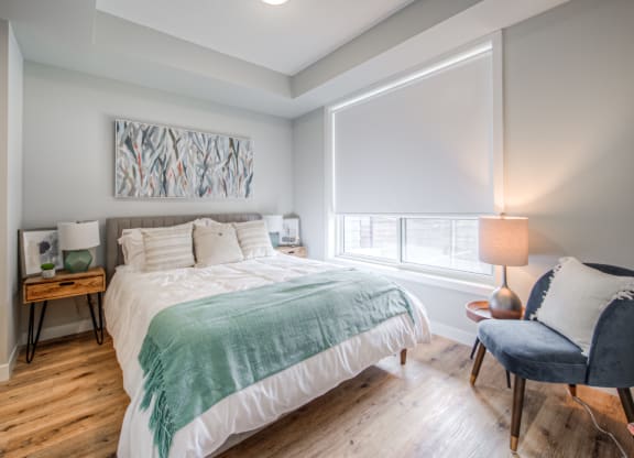 a bedroom with a bed and a chair
