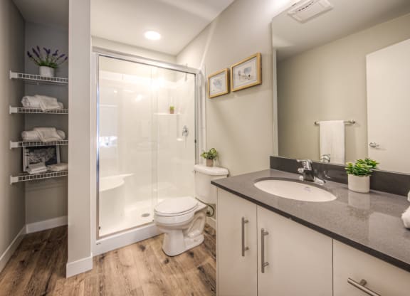 a bathroom with a toilet sink and shower