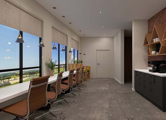 A conference room with a long table and chairs, a brick wall, and a view of the city.