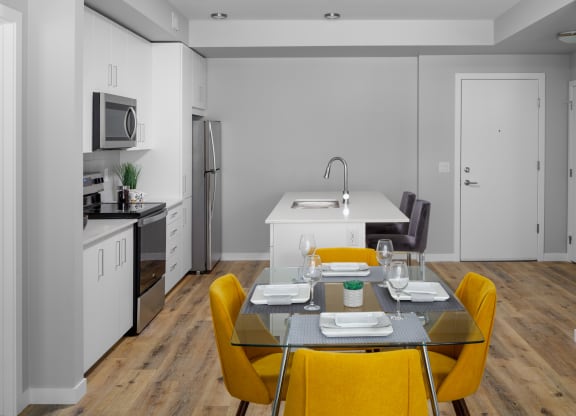 a kitchen and dining area in a 555 waverly unit