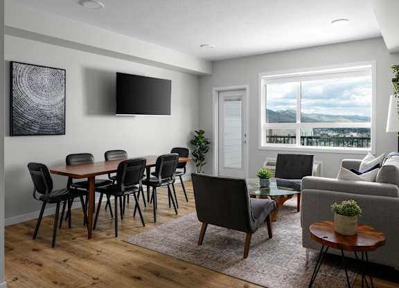 A modern living room with a wooden table and chairs.
