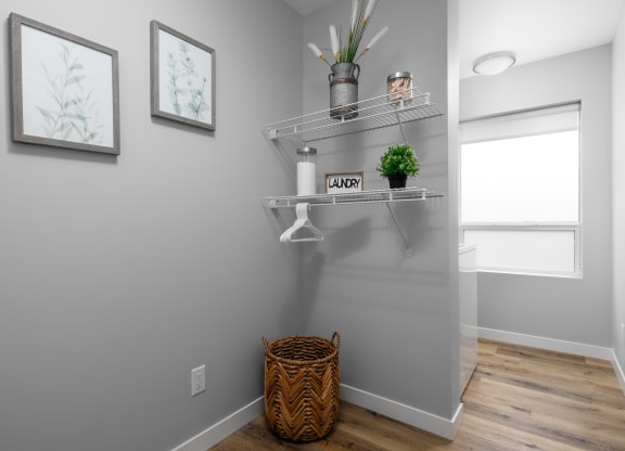 a small bathroom with grey walls and a basket on the floor