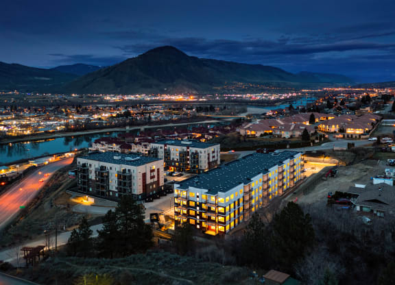 a city at night with a mountain in the background