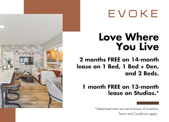 A room with a kitchen and a dining table with chairs and a sign that says EVOKE.