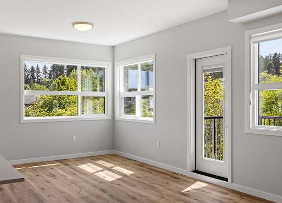A room with a large window and a door.
